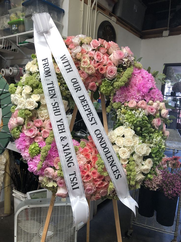 Elegant white lily and rose funeral wreath